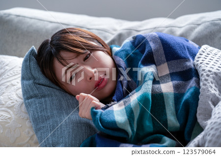 A young woman who is sick and falls asleep A young woman who is sick and falls asleep 123579064