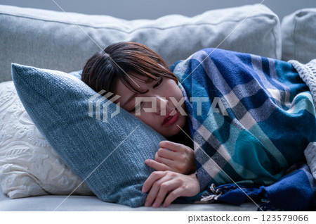 A young woman who is sick and falls asleep 123579066