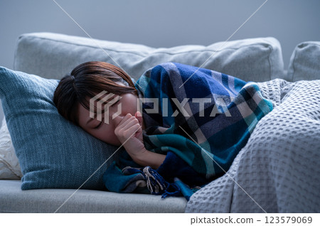 A young woman who is sick and falls asleep 123579069