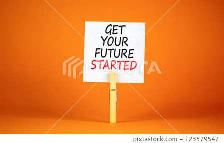 Get your future started symbol. Concept words Get your future started on beautiful white paper on clothespin. Beautiful orange background. Business get your future started concept. Copy space. Get your future started symbol. Concept words Get your future started on beautiful white paper on clothespin. Beautiful orange background. Business get your future started concept. Copy space. 123579542