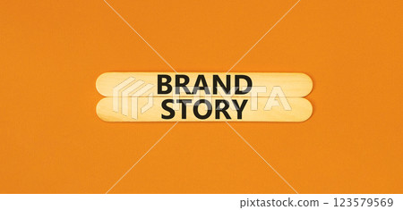Brand story branding symbol. Concept words Brand story on beautiful wooden sticks. Beautiful orange background. Business brand story branding concept. Copy space. Brand story branding symbol. Concept words Brand story on beautiful wooden sticks. Beautiful orange background. Business brand story branding concept. Copy space. 123579569