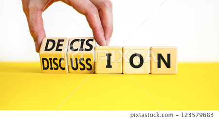 Discussion and decision symbol. Concept word Discussion and Decision on wooden cubes. Businessman hand. Beautiful yellow table white background. Business discussion and decision concept. Copy space. 123579683