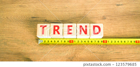 Trend and trending symbol. Concept word Trend on beautiful wooden blocks. Beautiful wooden table wooden background. Beautiful yellow ruler. Business lifestyle trend and trending concept. Copy space. 123579685