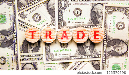 Trade symbol. Concept word Trade on beautiful wooden circles. Beautiful dollar bills. Beautiful background from dollar bills. Business lifestyle trade concept. Copy space. Trade symbol. Concept word Trade on beautiful wooden circles. Beautiful dollar bills. Beautiful background from dollar bills. Business lifestyle trade concept. Copy space. 123579698