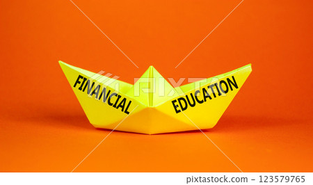 Financial education symbol. Concept words Financial education on beautiful yellow paper boat. Beautiful orange paper background. Business Financial education concept. Copy space. 123579765