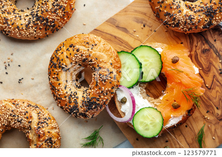 Assembling a lox bagel, overhead flat lay shot. Sandwich with smoked salmon 123579771
