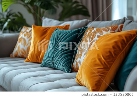 Elegant living room with a neutral sofa and decorative pillows in mustard yellow and deep green tones Elegant living room with a neutral sofa and decorative pillows in mustard yellow and deep green tones 123580805