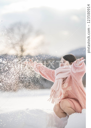 A young woman in a knitted outfit in the warm winter light A young woman in a knitted outfit in the warm winter light 123580914