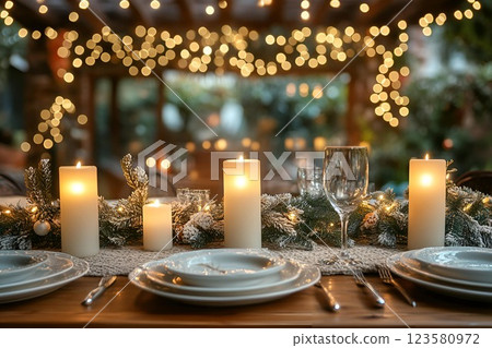 Elegant Christmas dinner table with candles, twinkling fairy lights, and festive decorations in a warm ambiance Elegant Christmas dinner table with candles, twinkling fairy lights, and festive decorations in a warm ambiance 123580972