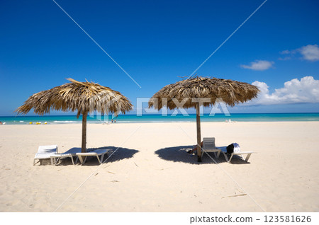 Beach with parasols and sunbeds 123581626