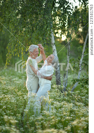 Beautiful elderly couple dancing in the park Beautiful elderly couple dancing in the park 123581763