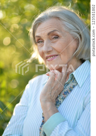 Portrait of a beautiful elderly woman in the park Portrait of a beautiful elderly woman in the park 123581802