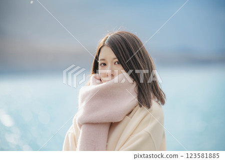 Portrait of a woman with blue sky and lake 123581885