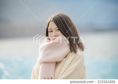 Portrait of a woman with blue sky and lake 123581889