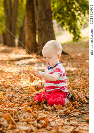 One-year-old little boy exploring the world in an autumn forest 123582401