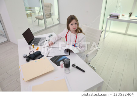 A Child Doctor Engaging in Playful Activities within a Modern Clinic Environment A Child Doctor Engaging in Playful Activities within a Modern Clinic Environment 123582404