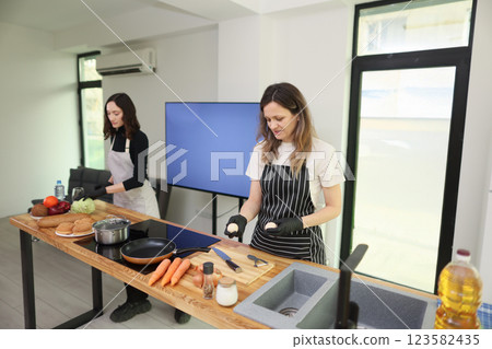 Engaging in a Cooking Class that Focuses on Using Fresh Vegetables in a Modern Kitchen Setting 123582435