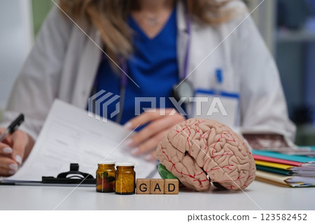 Doctor Engaged in Analyzing a Complex Patient Case Utilizing a Brain Model and GAD Acronym 123582452