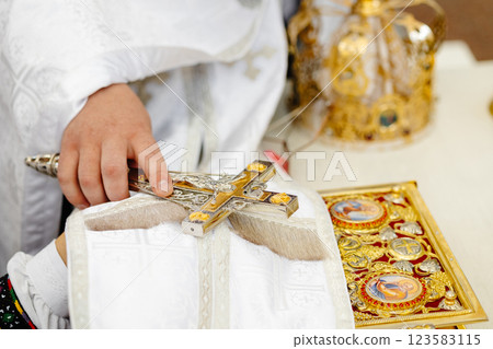 Priest holding a cross during a religious ceremony 123583115