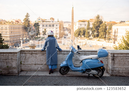 Elegant Woman Admiring Rome with Her Scooter 123583652