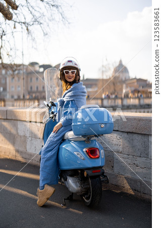 Stylish Traveler Exploring Rome by Scooter Stylish Traveler Exploring Rome by Scooter 123583661
