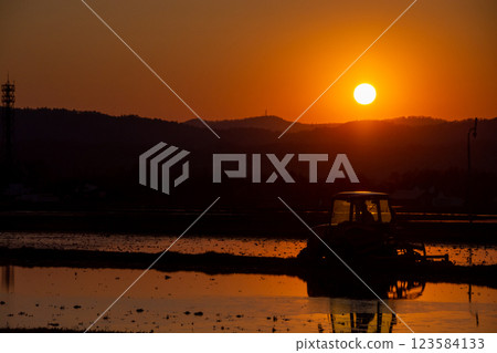 Farm work at dusk in spring - plowing Farm work at dusk in spring - plowing 123584133