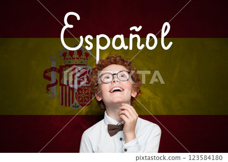 Happy child boy on Spanish flag with the inscription Espanol in Spanish. Happy child boy on Spanish flag with the inscription Espanol in Spanish. 123584180