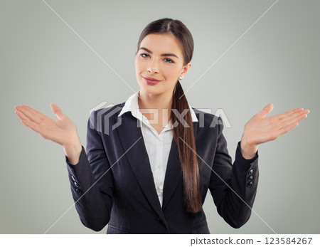 Smiling business woman looking at camera, smiling and holding empty palm hand on white background Smiling business woman looking at camera, smiling and holding empty palm hand on white background 123584267