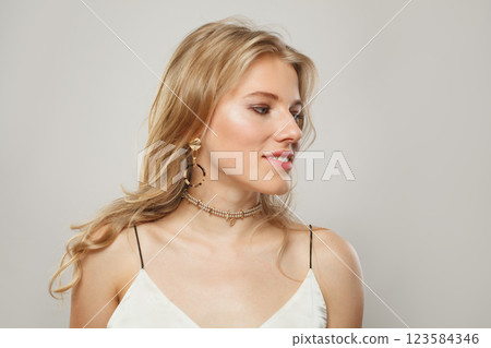 Stylish young blond female model with clear skin, soft make-up and healthy hair Stylish young blond female model with clear skin, soft make-up and healthy hair 123584346