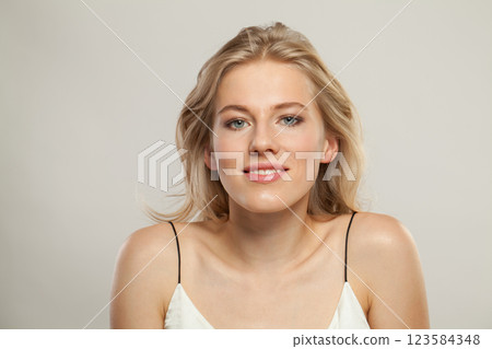 Cute smiling woman. Female model with blond hairstyle and clean skin 123584348
