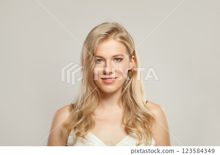 Charming young blond female model with clear skin, soft make-up and healthy hair  123584349