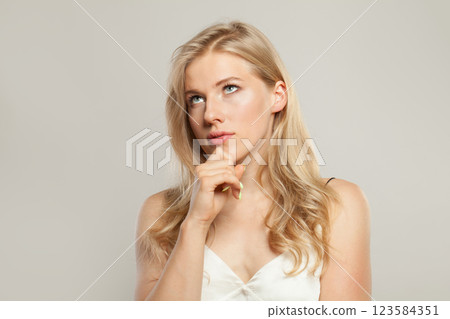 Thinking blond model woman portrait. Beautiful face with healthy clear skin, long shiny hair Thinking blond model woman portrait. Beautiful face with healthy clear skin, long shiny hair 123584351