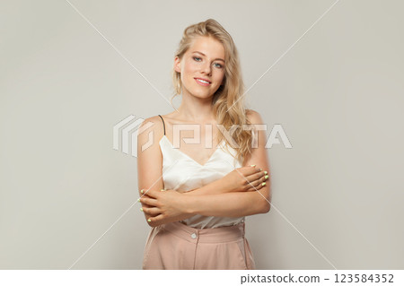 Confident blond woman with cute smile looking at camera. Beauty young adult person portrait Confident blond woman with cute smile looking at camera. Beauty young adult person portrait 123584352