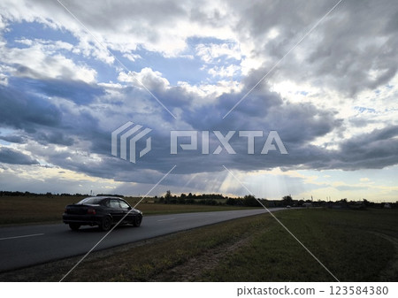 Mysterious mystical sky. A car on the highway enters a mystical area. 123584380