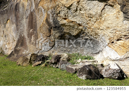 A small rock cavity at the bottom of a cliff A small rock cavity at the bottom of a cliff 123584955