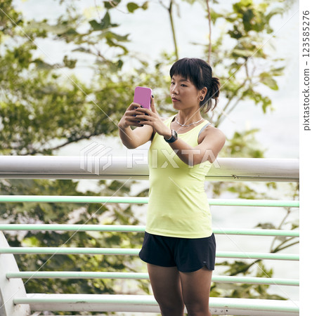 young asian woman taking a selfie outdoors young asian woman taking a selfie outdoors 123585276