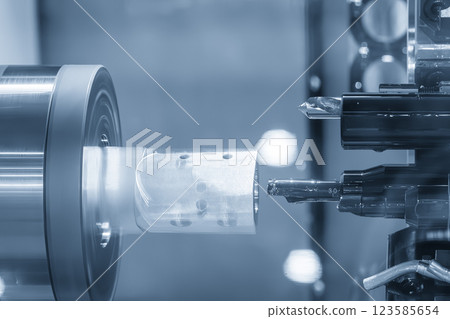 The  multi tasking CNC lathe machine swiss type bore cutting the metal tube parts. 123585654