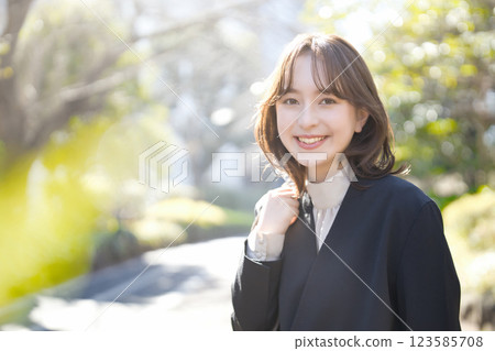 Young business woman walking in a suit 123585708