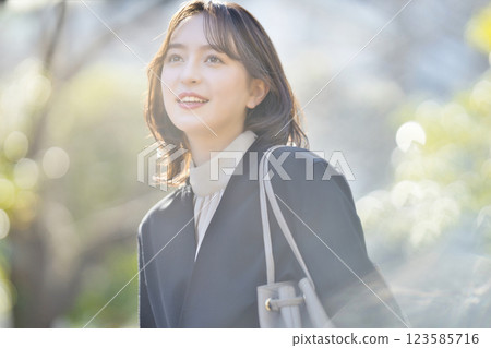 Young business woman walking in a suit Young business woman walking in a suit 123585716