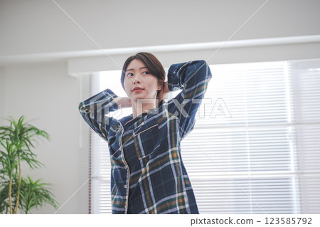 A woman preparing to tie her hair up A woman preparing to tie her hair up 123585792