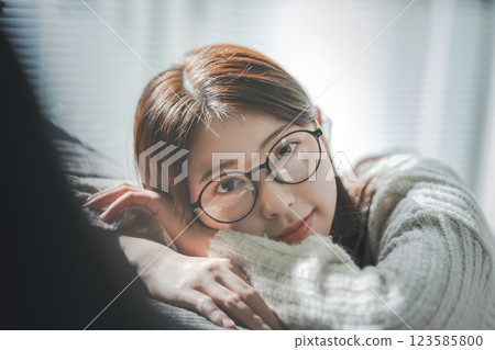 Woman with glasses relaxing on the sofa 123585800