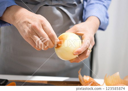 Hands of a middle-aged woman cutting vegetables Hands of a middle-aged woman cutting vegetables 123585874