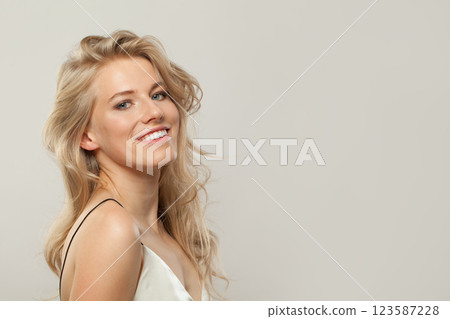 Attractive blond woman with cute smile looking at camera. Beauty young adult person portrait 123587228