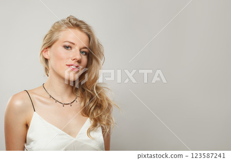 Nice blond model woman portrait. Beautiful face with healthy clear skin, long shiny hair 123587241