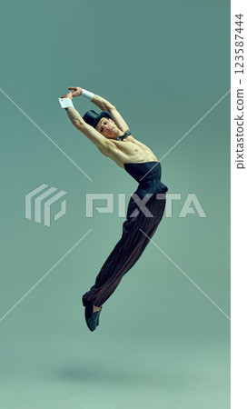 Majestic leap suspended in air, refined yet powerful stance embodying theatrical brilliance in vintage attire, radiating old-school charisma against artistic setting. 123587444