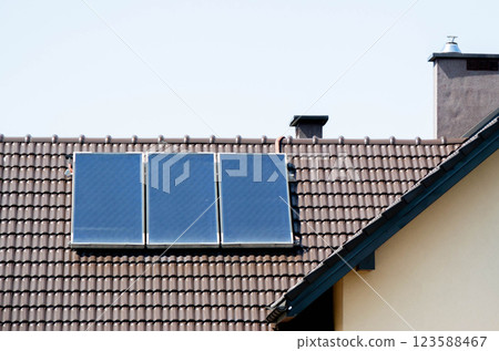 House roof with photovoltaic modules. Historic farm house with modern solar panels on roof and wall High quality photo House roof with photovoltaic modules. Historic farm house with modern solar panels on roof and wall High quality photo 123588467