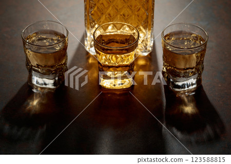 Decanter and small glasses of whiskey. Decanter and small glasses of whiskey. 123588815