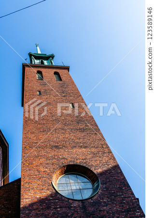 An impressive brick church tower stands tall against the clear blue sky in Helsinki. 123589146