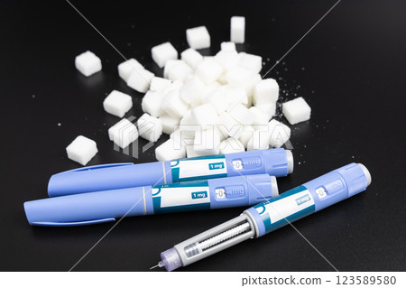 Ozempic Insulin injection pen on a dark background for diabetics and weight loss. Ozempic Insulin injection pen on a dark background for diabetics and weight loss. 123589580