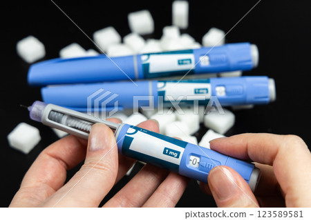 Ozempic Insulin injection pen on a dark background for diabetics and weight loss. Ozempic Insulin injection pen on a dark background for diabetics and weight loss. 123589581